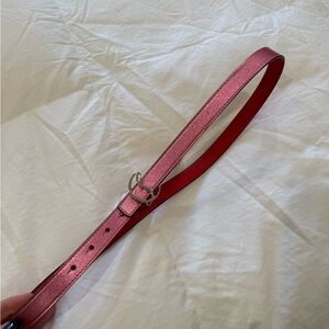 Pink leather belt with a sleek design and metal buckle